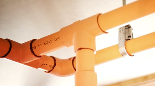 view of orange pipes on ceiling 