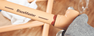 Person applying solvent to two ends of CPVC pipe