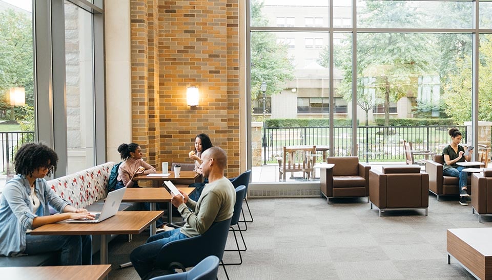People working in the lobby of what looks like a shared workspace