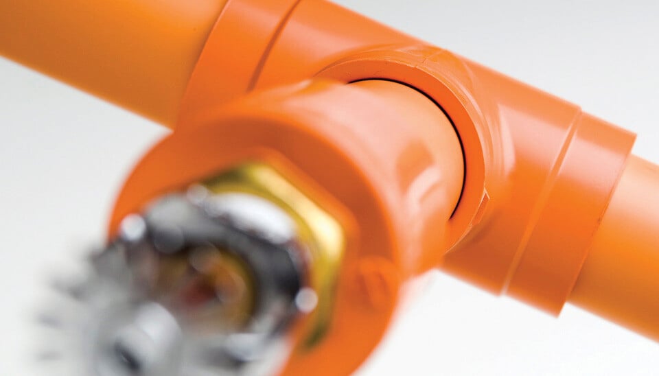 close up view of orange sprinkler pipe